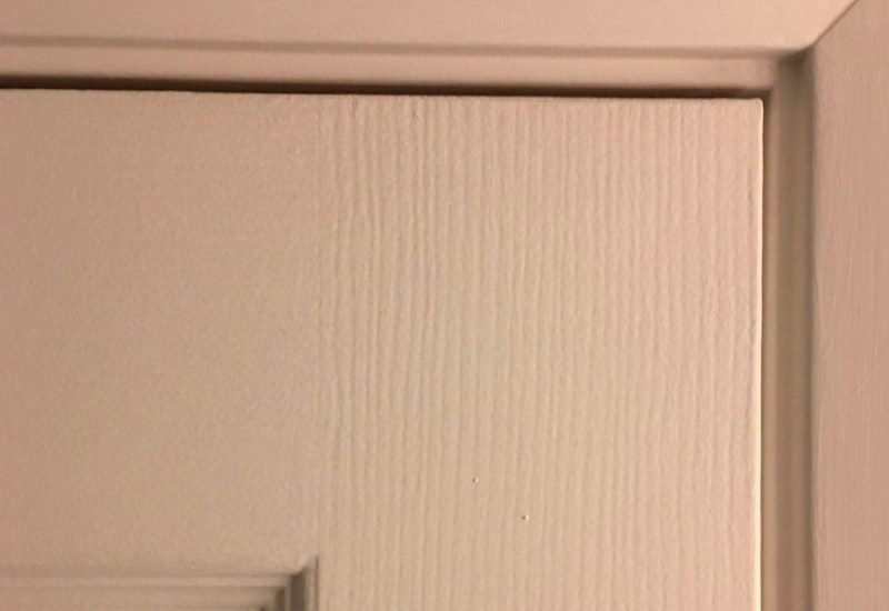 Locksmith checking the alignment of a door